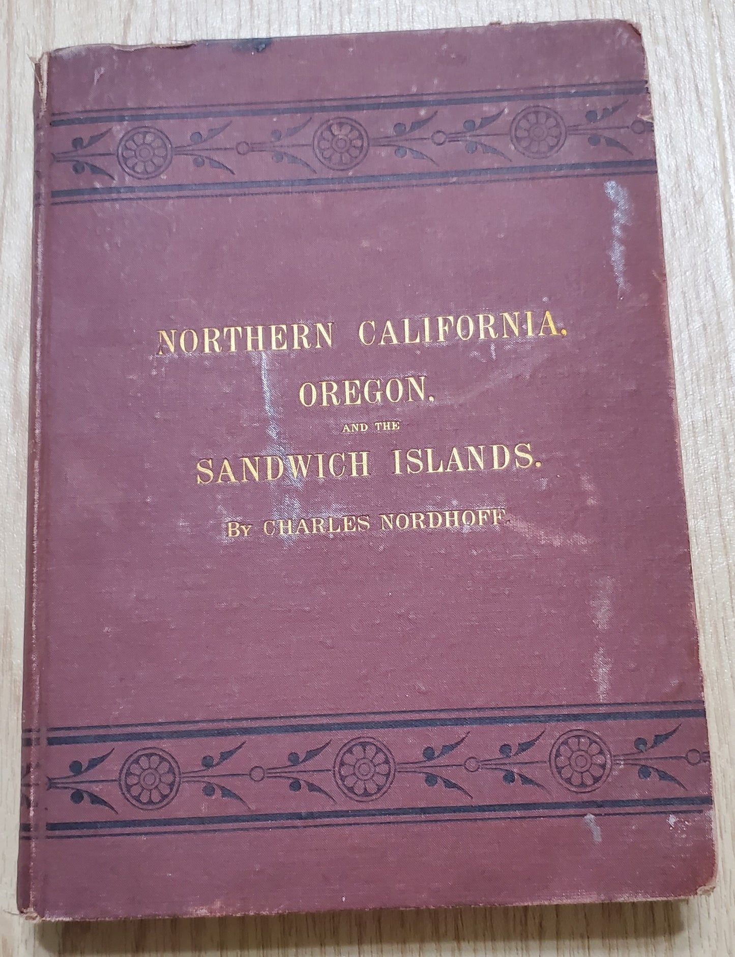 Nordhoff, Charles. Northern California, Oregon and the Sandwich Islands. 1874. 1st ed. Illus. Cloth, gilt. Cloth frayed, rubbed, bb-sized hole through first four pages, bookplate removed. VG