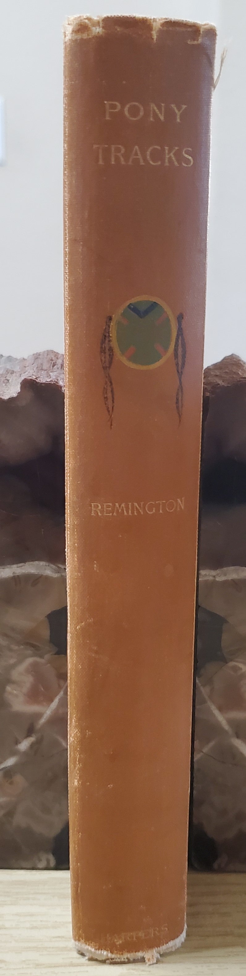 Remington, Frederick. Pony Tracks. NY: Harper & Bros, 1895. 1st ed. Pict cloth, gilt. Hinges broken, spine lean, fraying, some rubbing. VG
