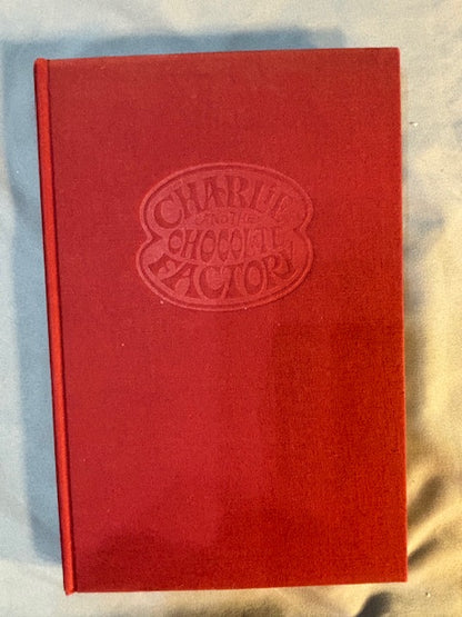 Dahl, Roald.  Charlie and the Chocolate Factory. NY: Alfred Knopf, (1964). 1st ed, 1st printing with red cloth, top edge brown and 6-line collophon on last page. 1st issue DJ with no ISBN number on rear panel Book is Near mint, DJ only Fair