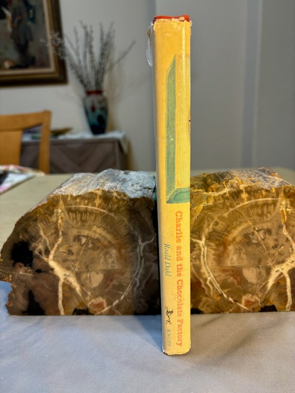 Dahl, Roald.  Charlie and the Chocolate Factory. NY: Alfred Knopf, (1964). 1st ed, 1st printing with red cloth, top edge brown and 6-line collophon on last page. 1st issue DJ with no ISBN number on rear panel Book is Near mint, DJ only Fair